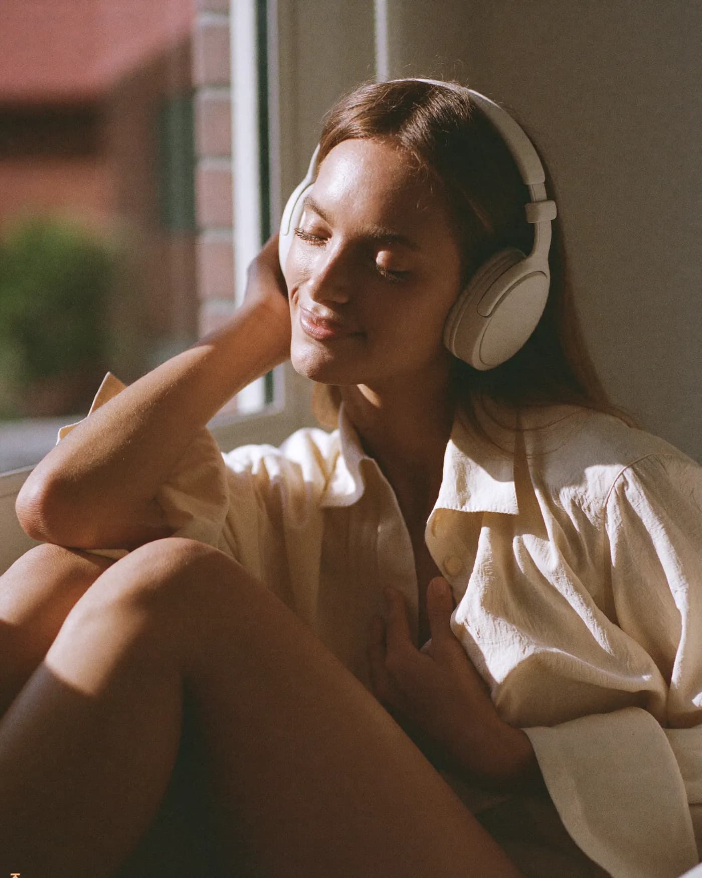 A woman listening with her eyes closed